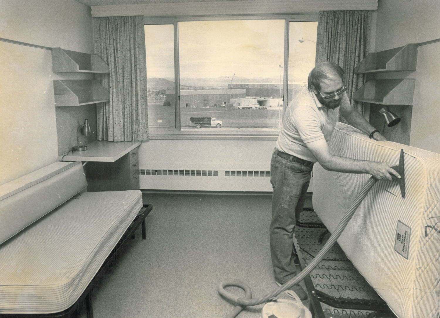 Worker cleans dorm rooms